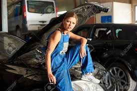 Black Car With An Open Hood And A Female-mechanic Sitting On ...