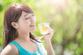 Beautiful Young Woman Drinking Hot Tea With Nature Green ...