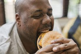 Man eating a big hamburger | Eat, Hamburger, Yummy dinners