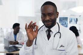 African Doctor Looking to the Camera with Team of Cowoker by sergii_kozii on Envato Elements