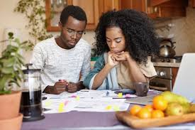 Free Photo | Young african couple doing paperwork together, sitting at  kitchen table with lots of papers