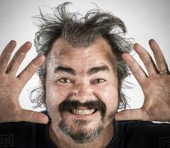 Man with messy hair making face - Stock Photo - Dissolve